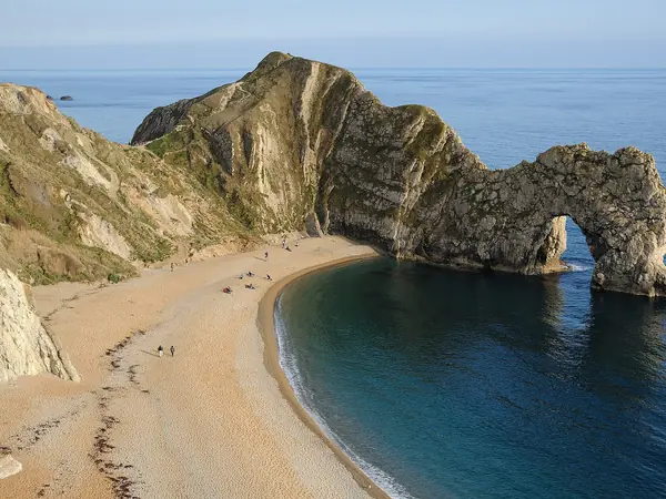 Durdle Door limestone arch and curving beach on the Jurassic Coast near Lulworth