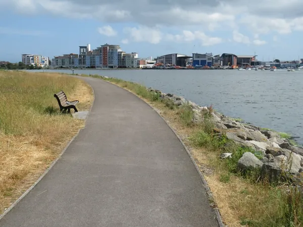 Poole Harbour Trail path running beside the water at Holes Bay, Poole