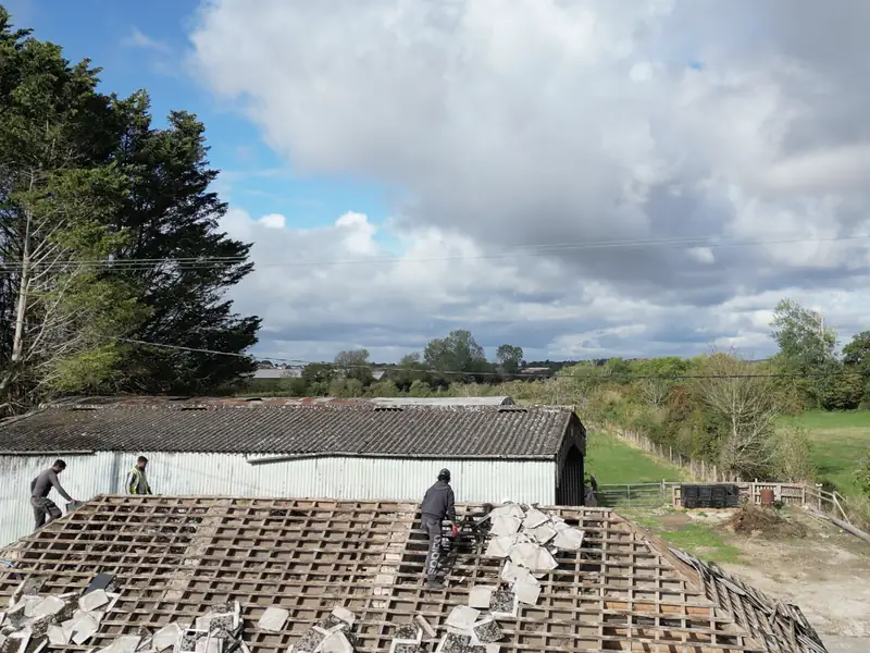 Old barn roof being stripped back to the purlins before re-covering