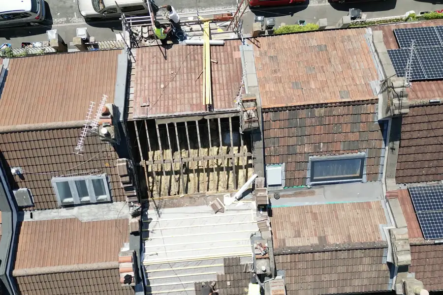 Aerial view of a terraced house mid re-roof, the kind of job our new roof prices are based on