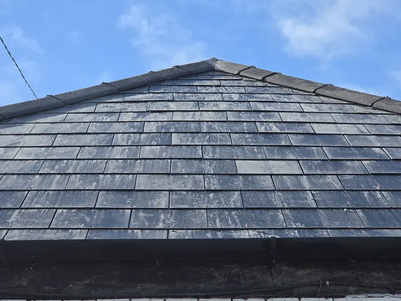 Finished natural slate roof with a new ridge line, completed by our team