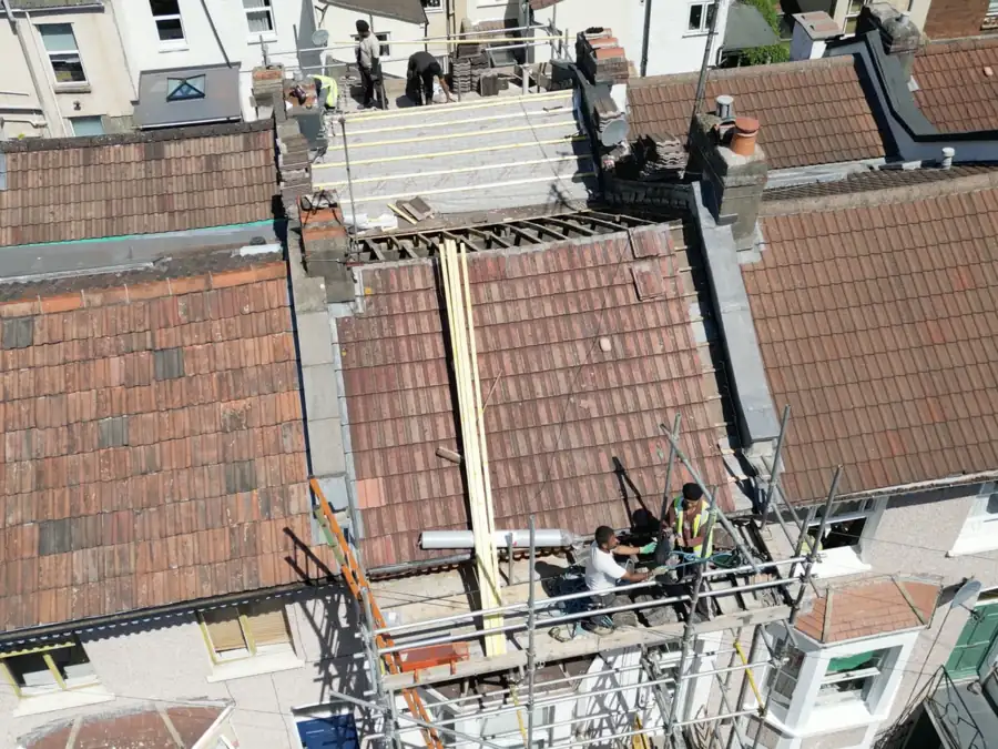 Our roofing team on the scaffold and roof of a terraced house during a full strip and re-roof