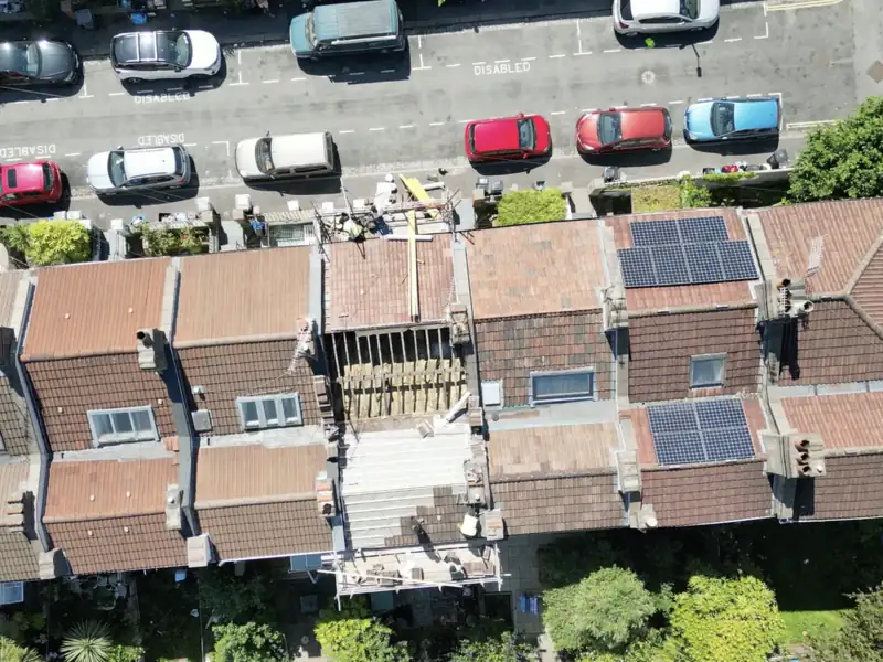 Aerial view of a terrace re-roof in progress, with the old covering stripped and new battens going on