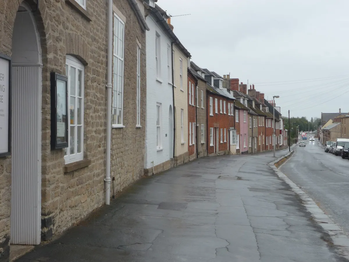 Stone and brick terraced houses lining South Street, Bridport