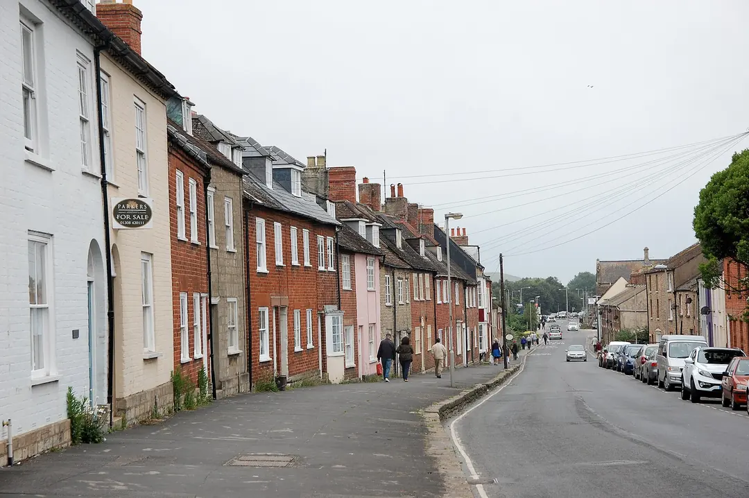Terraced houses with pitched roofs and chimneys along South Street in Bridport