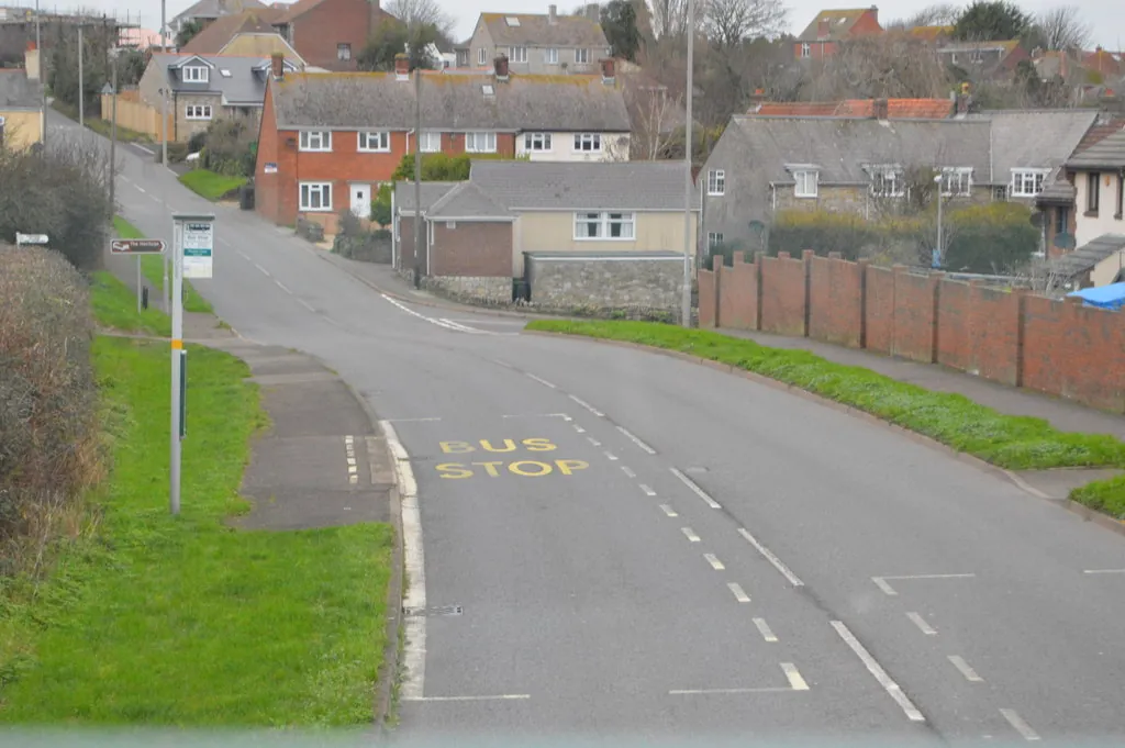 Houses with tiled roofs on the hill along Chickerell Road in Chickerell
