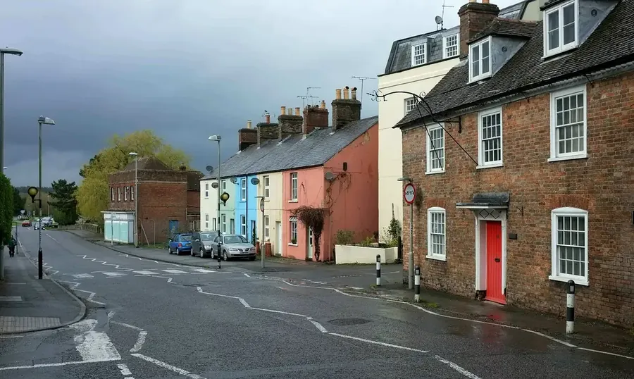 Colourful terraced cottages and a Georgian brick house with slate and tile roofs on North Street, Wareham